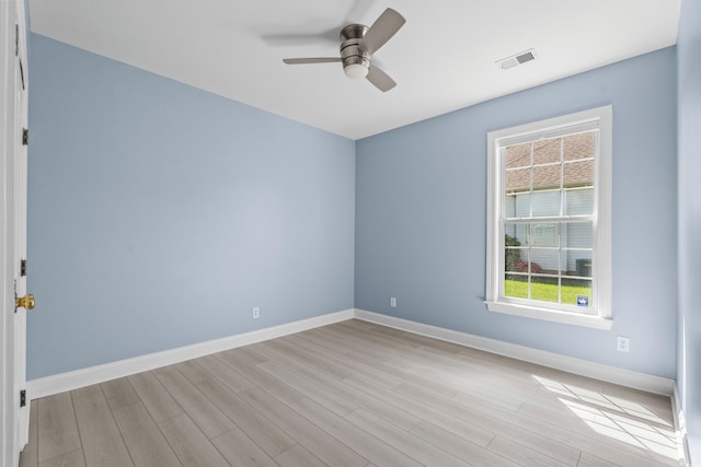 empty room featuring visible vents, light wood-style flooring, baseboards, and ceiling fan