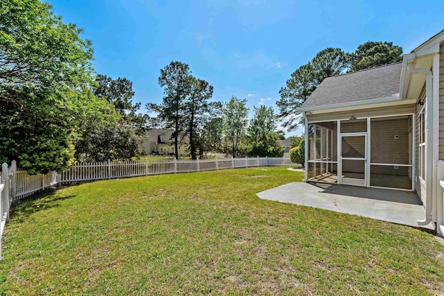 view of yard featuring a fenced backyard, a sunroom, and a patio area