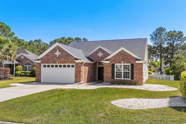 ranch-style home featuring fence, a front lawn, an attached garage, driveway, and brick siding