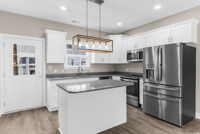 904 62nd Ave N Unit E, Myrtle Beach, SC 29572 - kitchen with visible vents, a sink, white cabinets, and stainless steel appliances