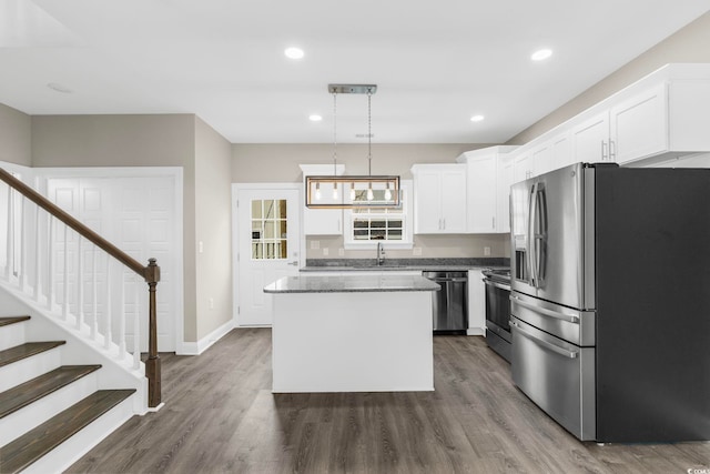 904 62nd Ave N Unit E, Myrtle Beach, SC 29572 - kitchen featuring dark wood-style flooring, a sink, stainless steel appliances, white cabinetry, and a kitchen island
