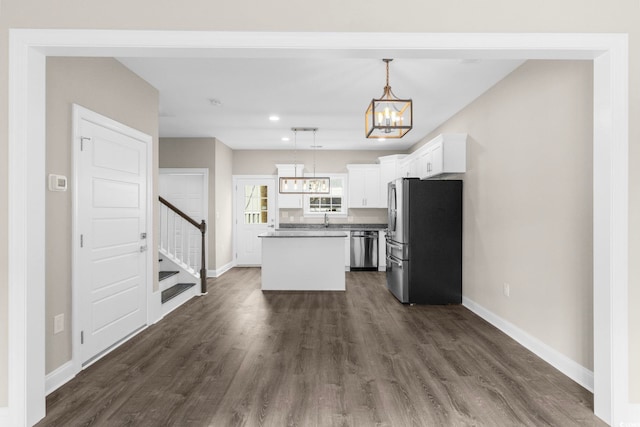 904 62nd Ave N Unit E, Myrtle Beach, SC 29572 - kitchen with baseboards, an inviting chandelier, a kitchen island, and stainless steel appliances