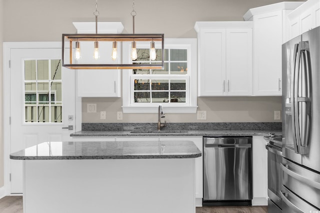 904 62nd Ave N Unit E, Myrtle Beach, SC 29572 - kitchen with wood finished floors, white cabinets, a sink, stone counters, and appliances with stainless steel finishes