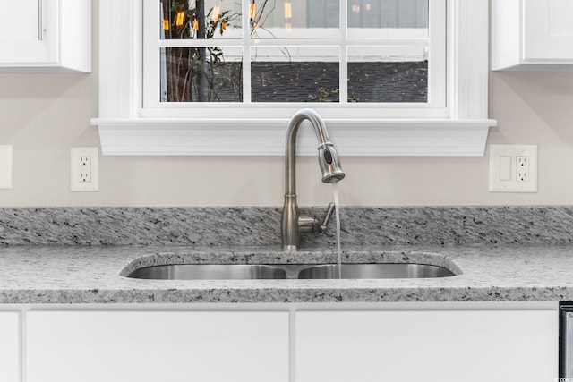 904 62nd Ave N Unit E, Myrtle Beach, SC 29572 - details with a sink, white cabinetry, and light stone countertops