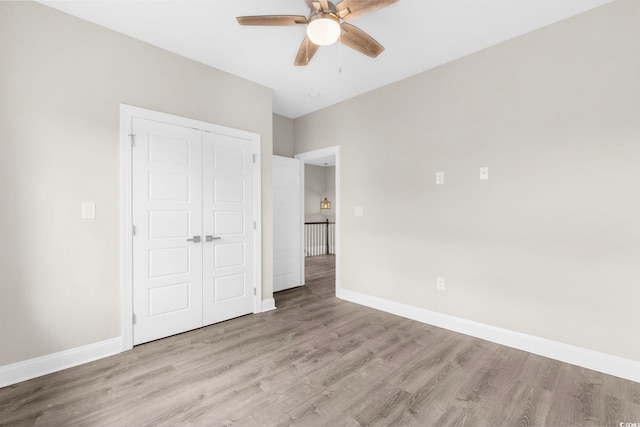 904 62nd Ave N Unit E, Myrtle Beach, SC 29572 - unfurnished bedroom with baseboards, a ceiling fan, a closet, and wood finished floors