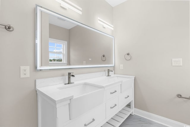 904 62nd Ave N Unit E, Myrtle Beach, SC 29572 - full bathroom with baseboards, double vanity, marble finish floor, and a sink