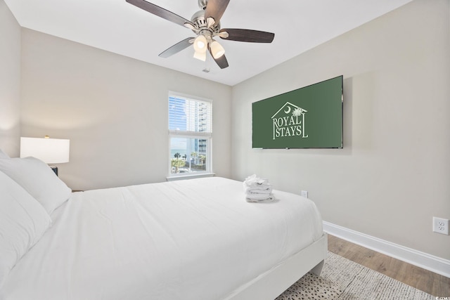 201-E Madison Ct, Myrtle Beach, SC 29577 - bedroom with baseboards, wood finished floors, and a ceiling fan