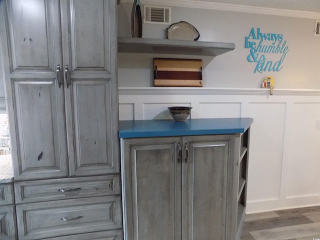 305 N Hillside Dr N Unit 103, North Myrtle Beach, SC 29582 - detailed view of a decorative wall, crown molding, and wood finished floors