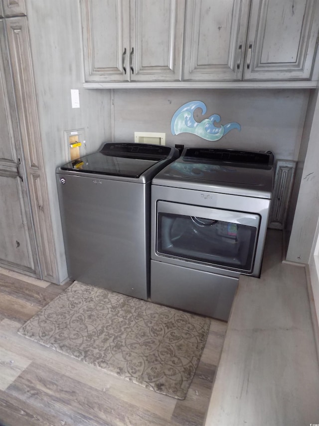 305 N Hillside Dr N Unit 103, North Myrtle Beach, SC 29582 - washroom featuring washer and clothes dryer and cabinet space