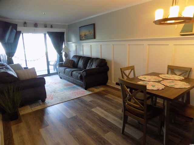305 N Hillside Dr N Unit 103, North Myrtle Beach, SC 29582 - living area with ornamental molding, a chandelier, a decorative wall, wood finished floors, and wainscoting
