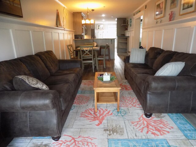 305 N Hillside Dr N Unit 103, North Myrtle Beach, SC 29582 - living room featuring a decorative wall, light wood finished floors, and a wainscoted wall