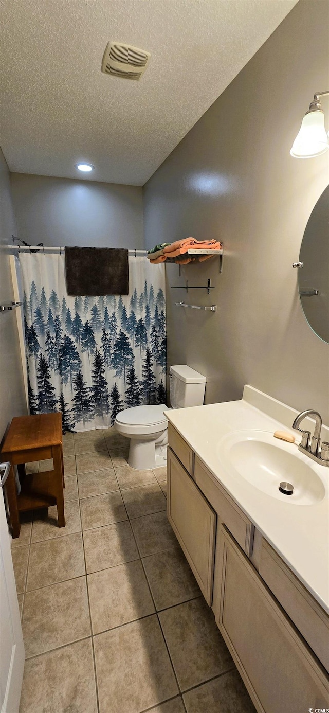 1100 Commons Blvd Unit 606, Myrtle Beach, SC 29572 - full bathroom with a textured ceiling, vanity, toilet, tile patterned floors, and a shower with shower curtain