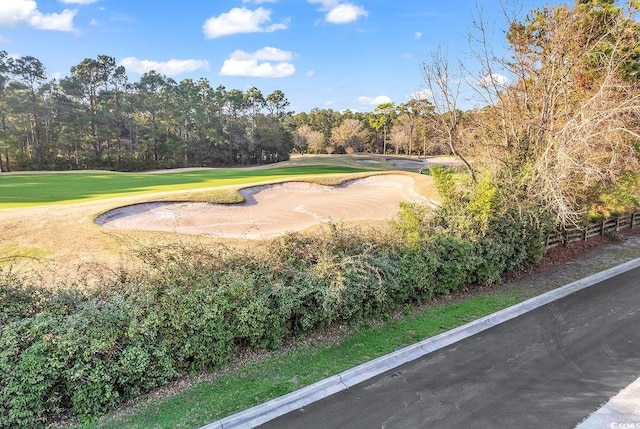 surrounding community with a lawn and golf course view