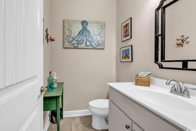 bathroom with vanity, tile patterned flooring, and toilet