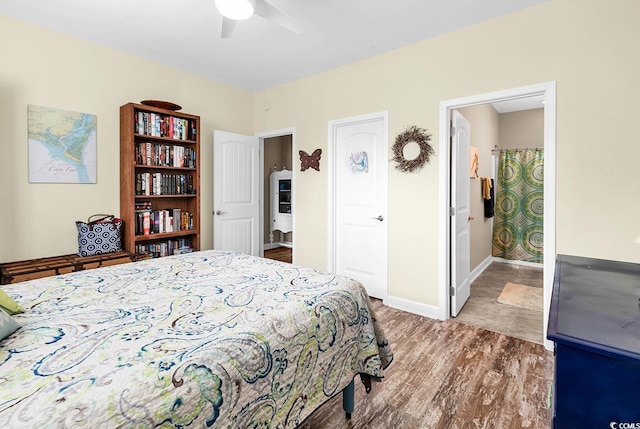 bedroom featuring ceiling fan, baseboards, and wood finished floors