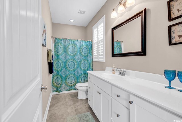 bathroom featuring vanity, baseboards, toilet, tile patterned flooring, and visible vents