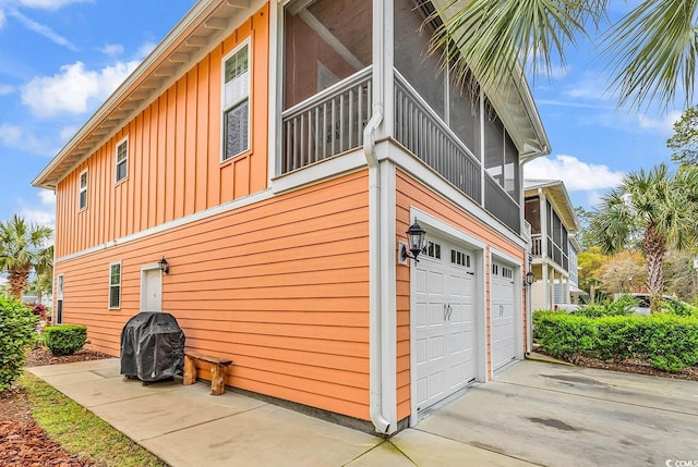 view of side of property with board and batten siding and an attached garage