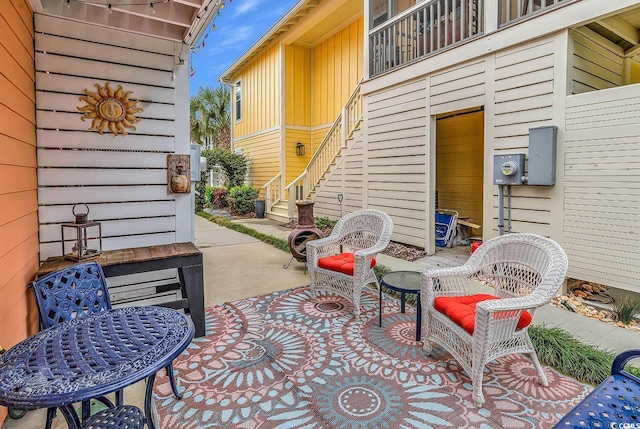 view of patio / terrace featuring stairway and a balcony