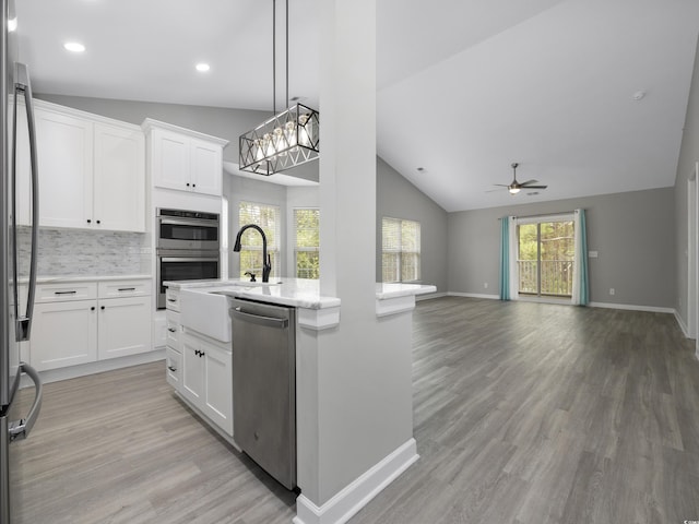 4854 Meadowsweet Dr Unit 1909, Myrtle Beach, SC 29579 - kitchen with stainless steel appliances, vaulted ceiling, a ceiling fan, light wood finished floors, and open floor plan