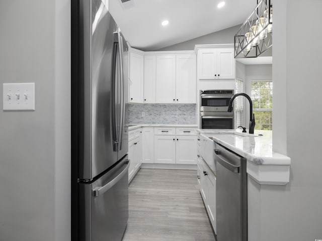 4854 Meadowsweet Dr Unit 1909, Myrtle Beach, SC 29579 - kitchen with stainless steel appliances, decorative backsplash, white cabinets, light wood-style flooring, and vaulted ceiling