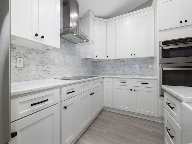 4854 Meadowsweet Dr Unit 1909, Myrtle Beach, SC 29579 - kitchen with wall chimney range hood, stainless steel double oven, black electric cooktop, white cabinets, and tasteful backsplash