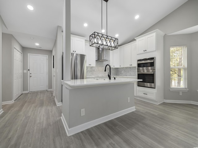 4854 Meadowsweet Dr Unit 1909, Myrtle Beach, SC 29579 - kitchen with appliances with stainless steel finishes, light countertops, backsplash, wall chimney range hood, and white cabinetry