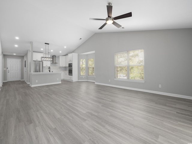 4854 Meadowsweet Dr Unit 1909, Myrtle Beach, SC 29579 - unfurnished living room with a ceiling fan, lofted ceiling, light wood-style floors, and recessed lighting