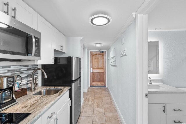 9550 Shore Dr Unit 1026, Myrtle Beach, SC 29572 - kitchen featuring appliances with stainless steel finishes, a sink, and white cabinetry