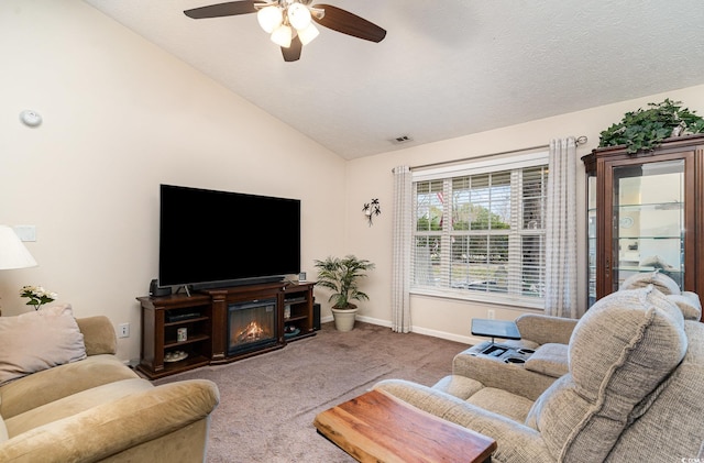 carpeted living area with vaulted ceiling, baseboards, a ceiling fan, and visible vents