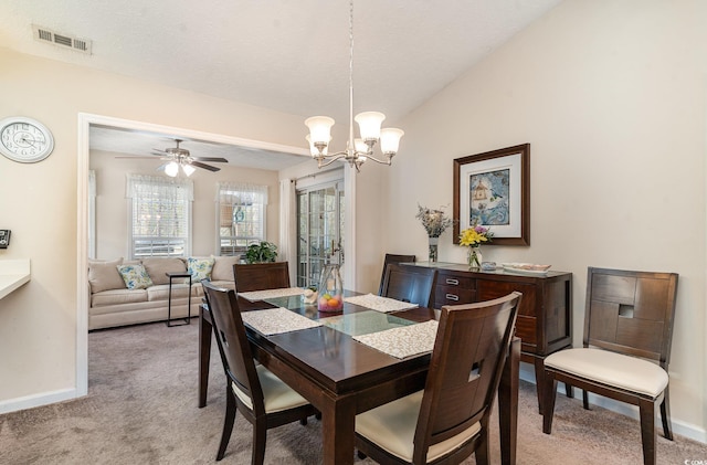 dining room with a chandelier, baseboards, visible vents, and light carpet