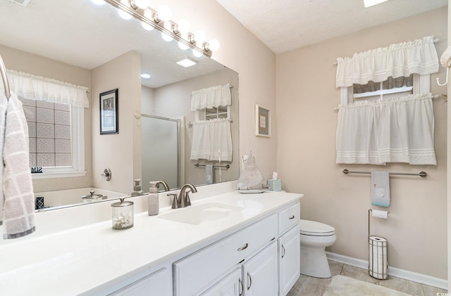 full bath featuring tile patterned flooring, a stall shower, vanity, baseboards, and toilet
