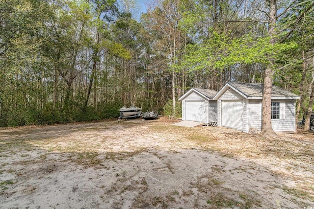 view of yard featuring a storage shed and an outbuilding