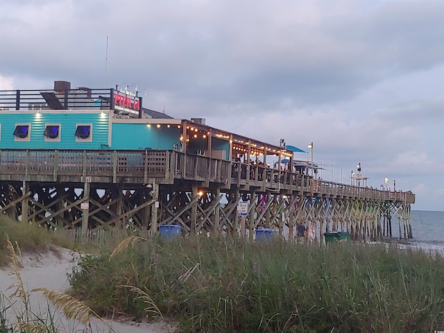 exterior space with a water view and a pier