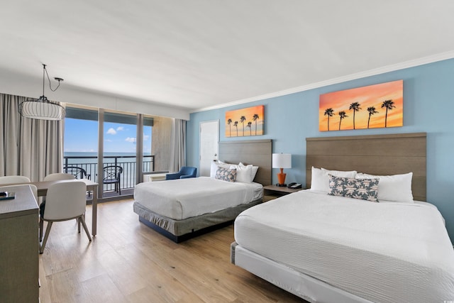 7100 N Ocean Blvd Unit 907, Myrtle Beach, SC 29572 - bedroom featuring light wood-style flooring, access to outside, crown molding, and a water view