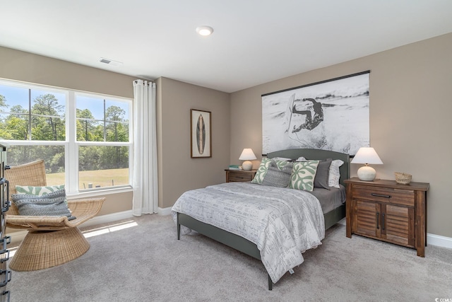carpeted bedroom with baseboards and visible vents