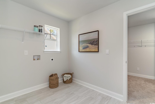 washroom with baseboards, hookup for an electric dryer, laundry area, and washer hookup