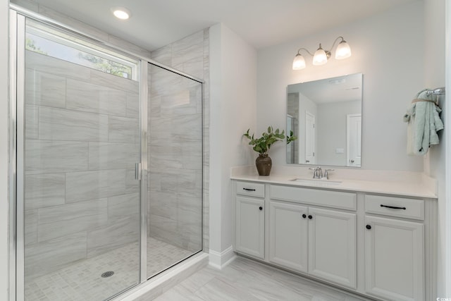bathroom with vanity, marble finish floor, and a shower stall