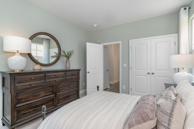 bedroom with baseboards and a closet