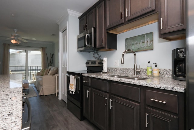 kitchen with crown molding, a ceiling fan, electric range, stainless steel microwave, and a sink