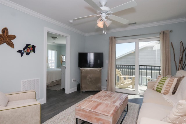 living area with crown molding, ceiling fan, baseboards, wood finished floors, and visible vents