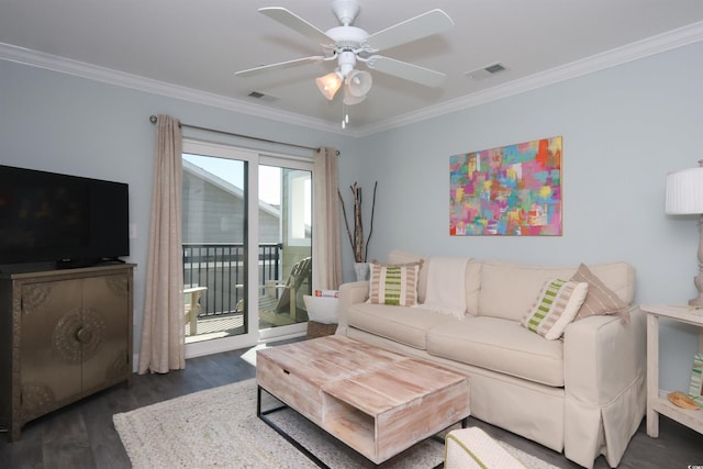 living room with crown molding, ceiling fan, visible vents, and wood finished floors