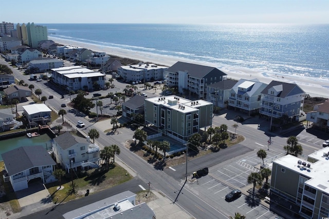 drone / aerial view with a water view and a view of the beach