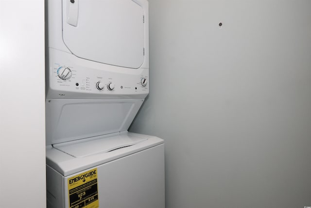 washroom with stacked washer / drying machine and laundry area