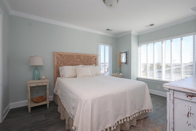bedroom featuring baseboards, visible vents, dark wood-style floors, and ornamental molding