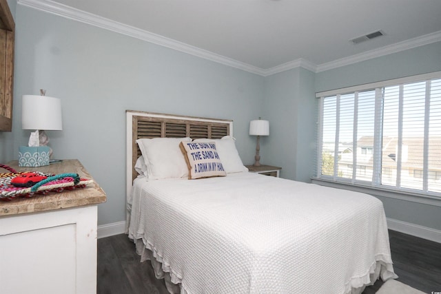 bedroom featuring visible vents, baseboards, crown molding, and dark wood finished floors