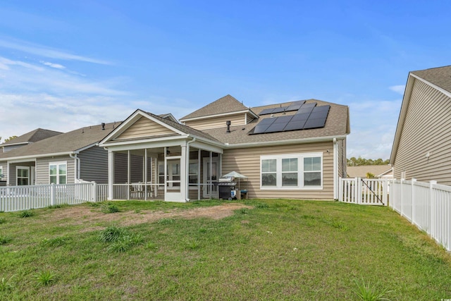 852 Harrison Mill St, Myrtle Beach, SC 29579 - rear view of house with a sunroom, solar panels, a shingled roof, and a fenced backyard