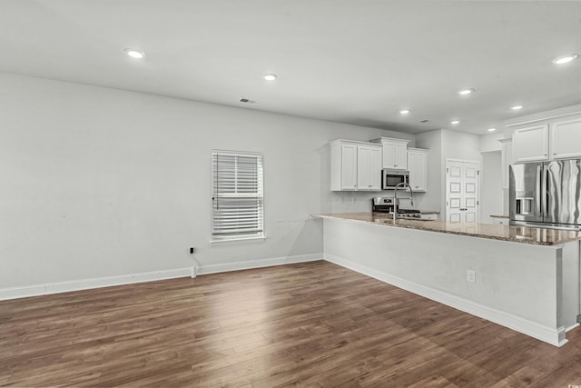 852 Harrison Mill St, Myrtle Beach, SC 29579 - kitchen featuring appliances with stainless steel finishes, dark wood finished floors, recessed lighting, a peninsula, and white cabinets