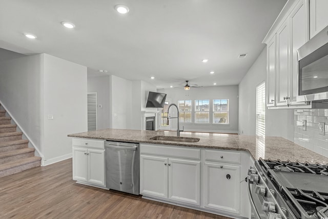 852 Harrison Mill St, Myrtle Beach, SC 29579 - kitchen featuring appliances with stainless steel finishes, a ceiling fan, white cabinetry, recessed lighting, and light stone countertops