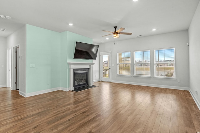 852 Harrison Mill St, Myrtle Beach, SC 29579 - unfurnished living room featuring a ceiling fan, a glass covered fireplace, wood finished floors, and recessed lighting
