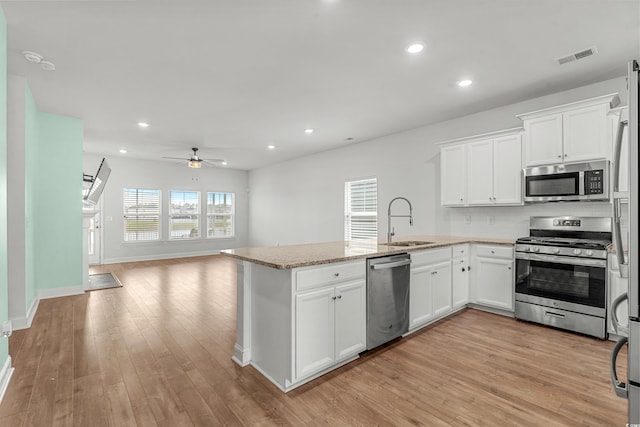 852 Harrison Mill St, Myrtle Beach, SC 29579 - kitchen featuring stainless steel appliances, ceiling fan, open floor plan, a peninsula, and light wood finished floors